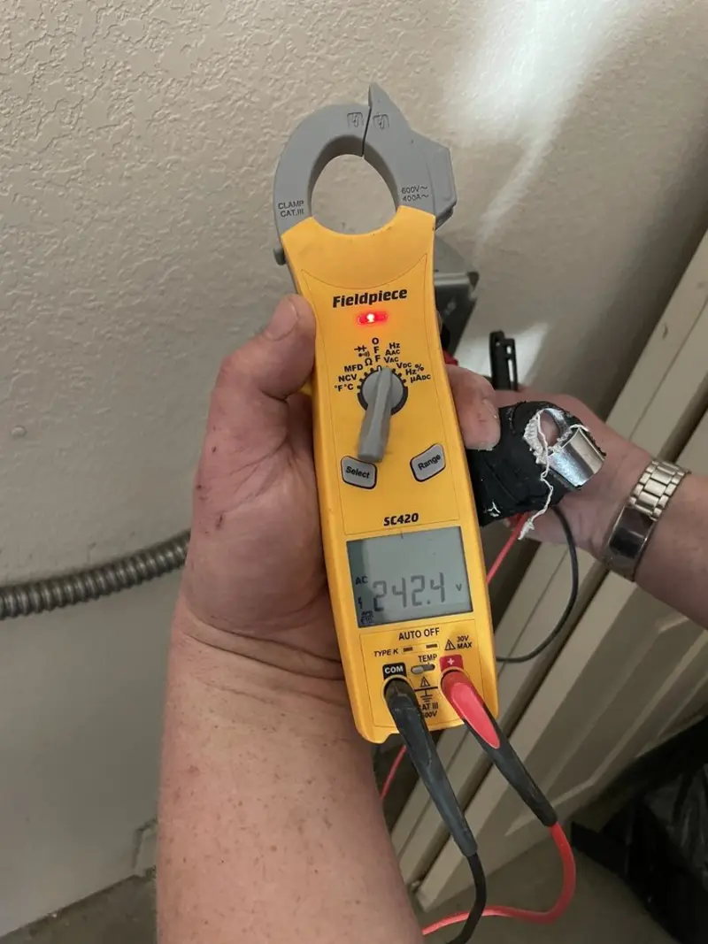 Voltage testing with clamp meter during Electrical Installation Services in Oliver Springs